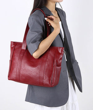 Large deep red handbag with spacious chamber and long strap