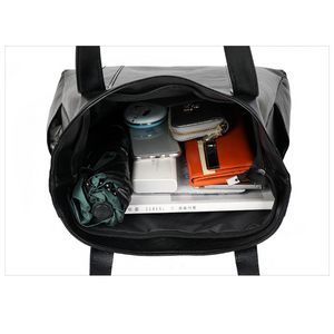 Black shoulder bag interior showing storage capacity
